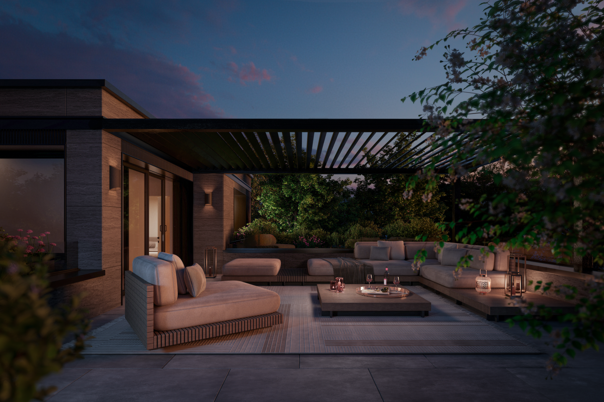Terrasse d’attique aménagée au crépuscule avec salon extérieur, végétation et éclairage chaleureux.