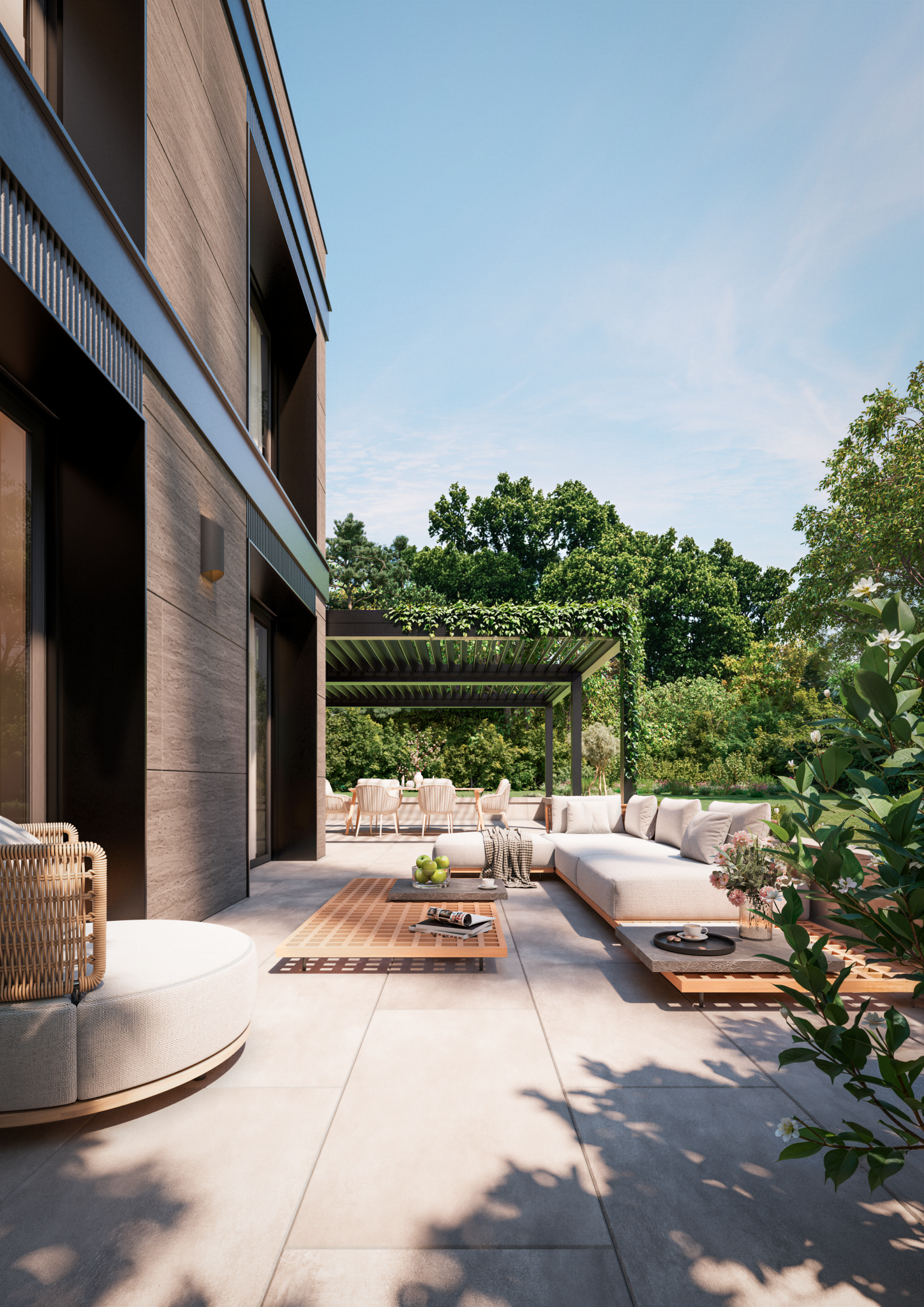 Terrasse de rez-de-jardin avec mobilier extérieur, végétation et lumière naturelle.