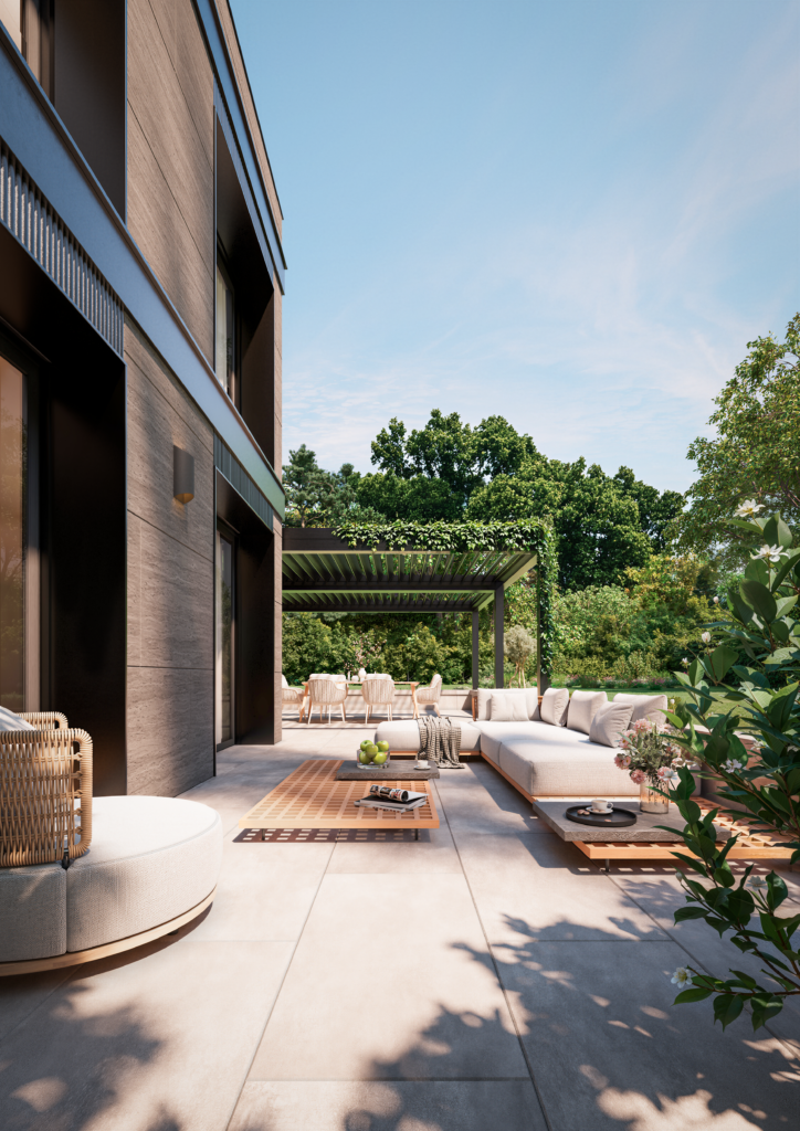 Terrasse de rez-de-jardin avec mobilier extérieur, végétation et lumière naturelle.