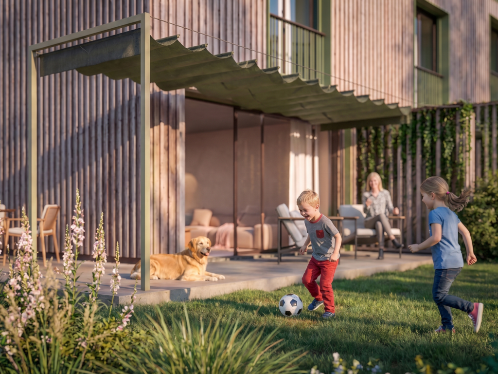 Enfants jouant dans le jardin d’une résidence contemporaine avec terrasse, façade en bois et ambiance familiale.